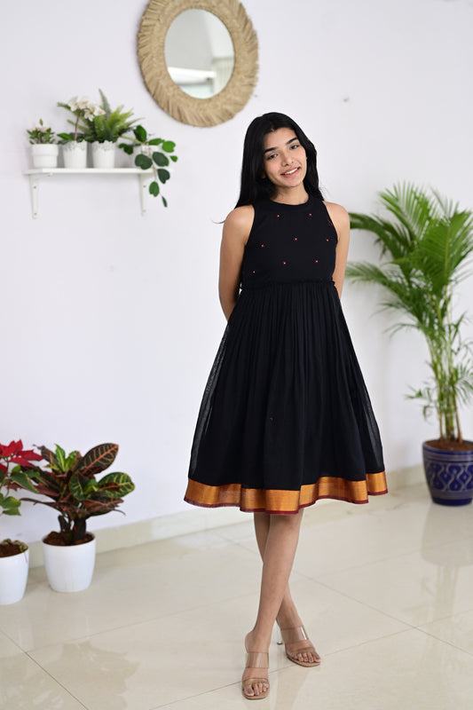 Narayanpet black dress featuring red thread knot embroidery with single pearl accents on each motif, handmade from authentic Narayanpet handloom fabric, showcasing traditional modern fusion.