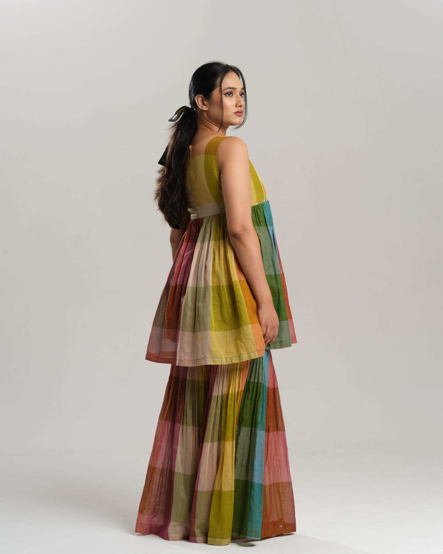 Model wearing a handwoven Narayanpet cotton sharara set in vibrant multicolour checks with embroidery detailing.
