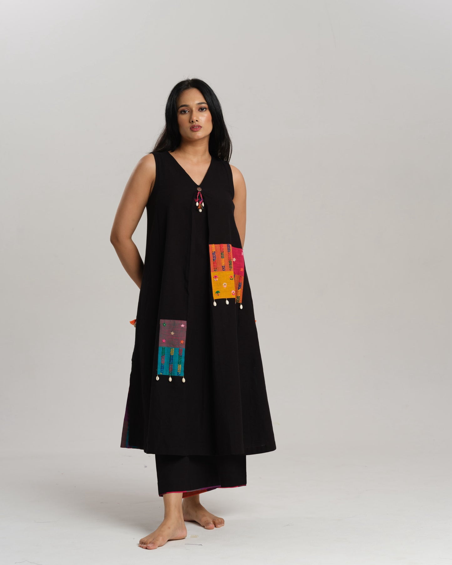 Model wearing Charcoal Charm – Ikat Kurta Set by Taram, black cotton kurta with patchwork, pants and vibrant South checks stole.