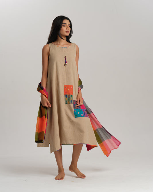 Model wearing a sleeveless beige Ikat cotton dress with colourful patchwork and Narayanpet dupatta – Ikat Rhythm dress for women by Taram.
