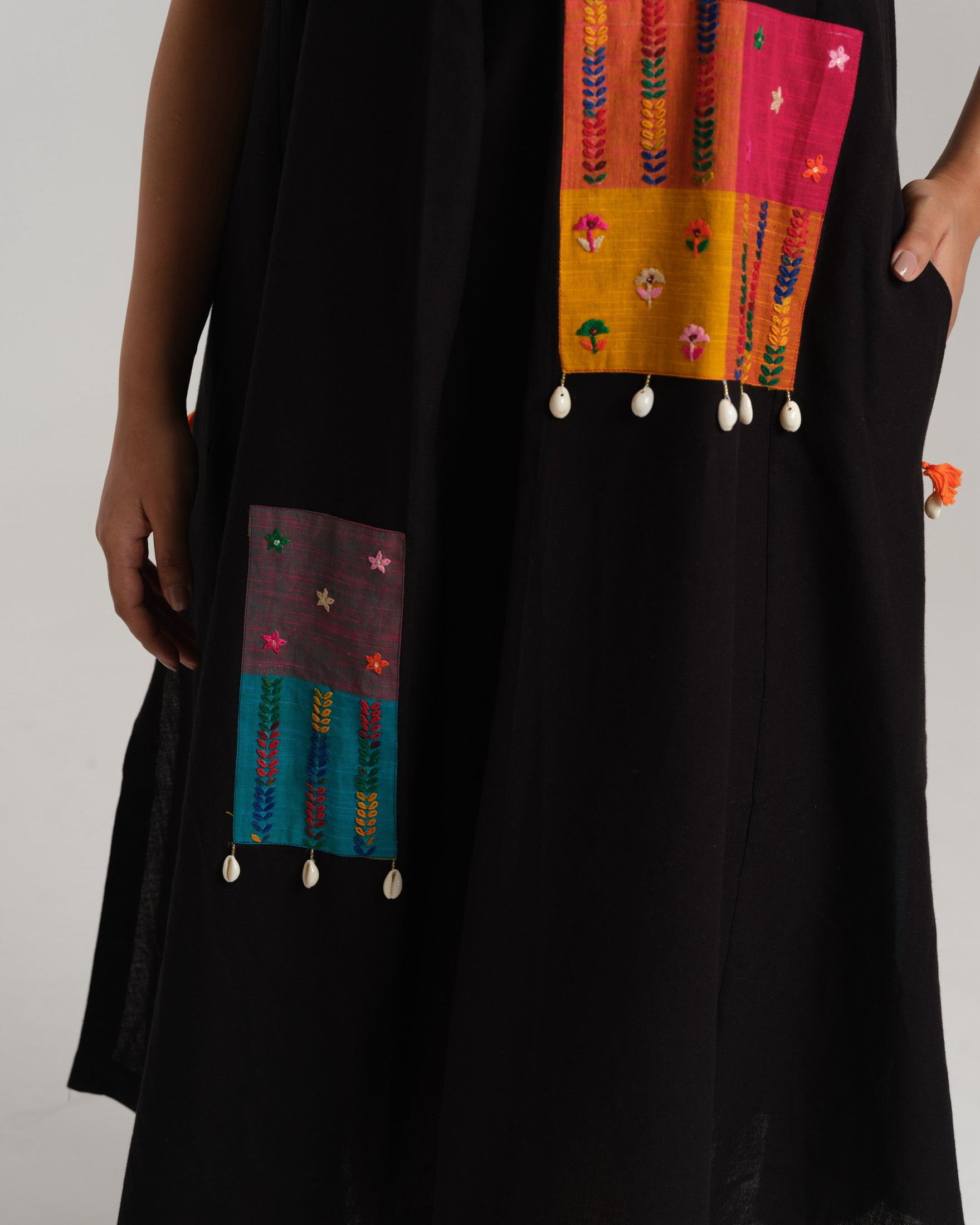 Model wearing Charcoal Charm – Ikat Kurta Set by Taram, black cotton kurta with patchwork, pants and vibrant South checks stole.