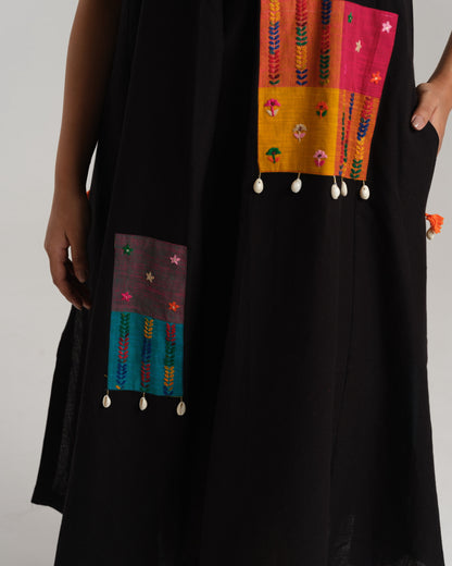 Model wearing Charcoal Charm – Ikat Kurta Set by Taram, black cotton kurta with patchwork, pants and vibrant South checks stole.