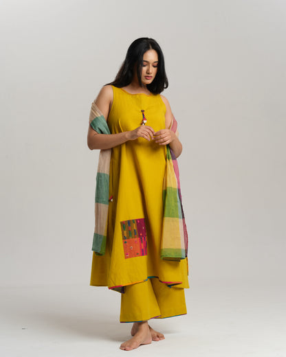 Model in mustard handwoven Ikat kurta set with patchwork pockets, wide pants, and a multi-color stole—Taram’s Sunkissed Loom with artisanal styling
