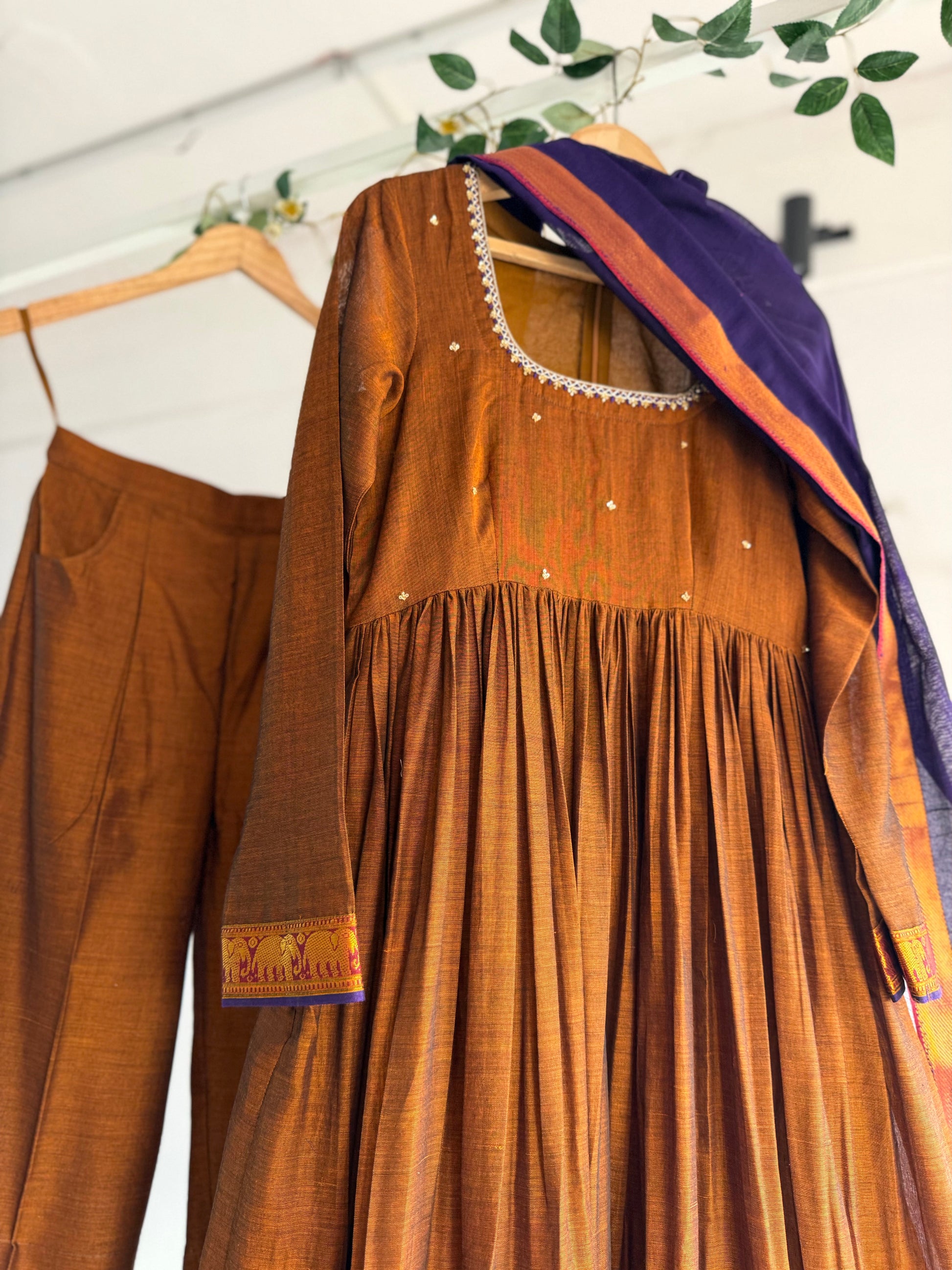 Shop The Copper Crown Kurtha Set at The Taram. A rich copper-toned handloom kurtha set with traditional zari borders, crafted for timeless elegance and festive wear.