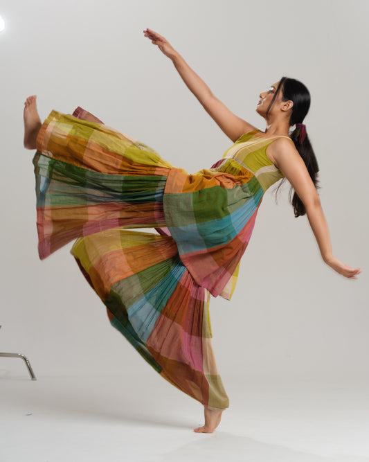 Model wearing a handwoven Narayanpet cotton sharara set in vibrant multicolour checks with embroidery detailing.