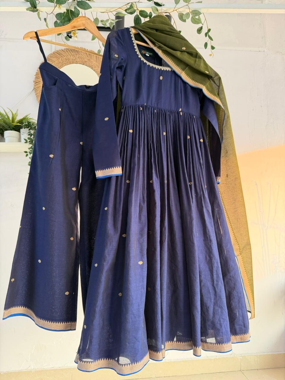 Midnight Blue Kurtha Set – deep navy handloom kurtha with subtle zari accents, matching bottoms, and coordinated dupatta displayed on hanger.