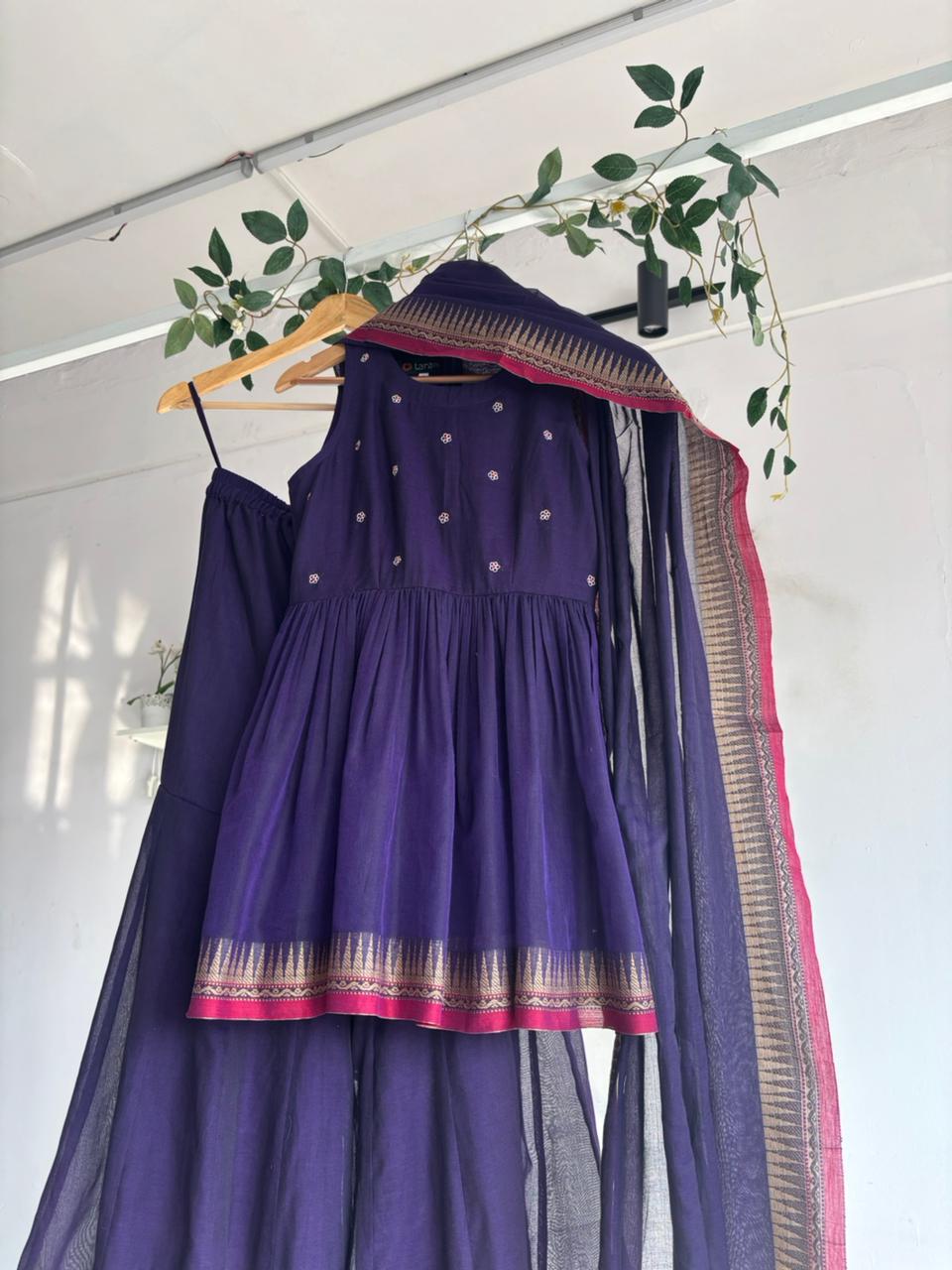 Purple Narayanpet Sharara Set – handloom purple kurta with gold motifs, flared sharara, and matching dupatta with zari border displayed on hanger.