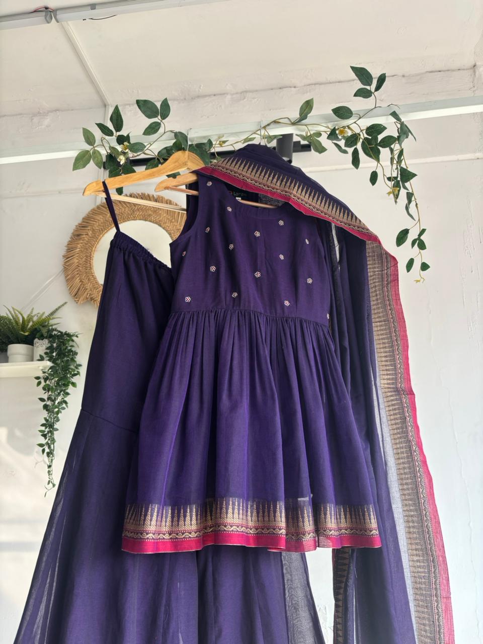 Purple Narayanpet Sharara Set – handloom purple kurta with gold motifs, flared sharara, and matching dupatta with zari border displayed on hanger.