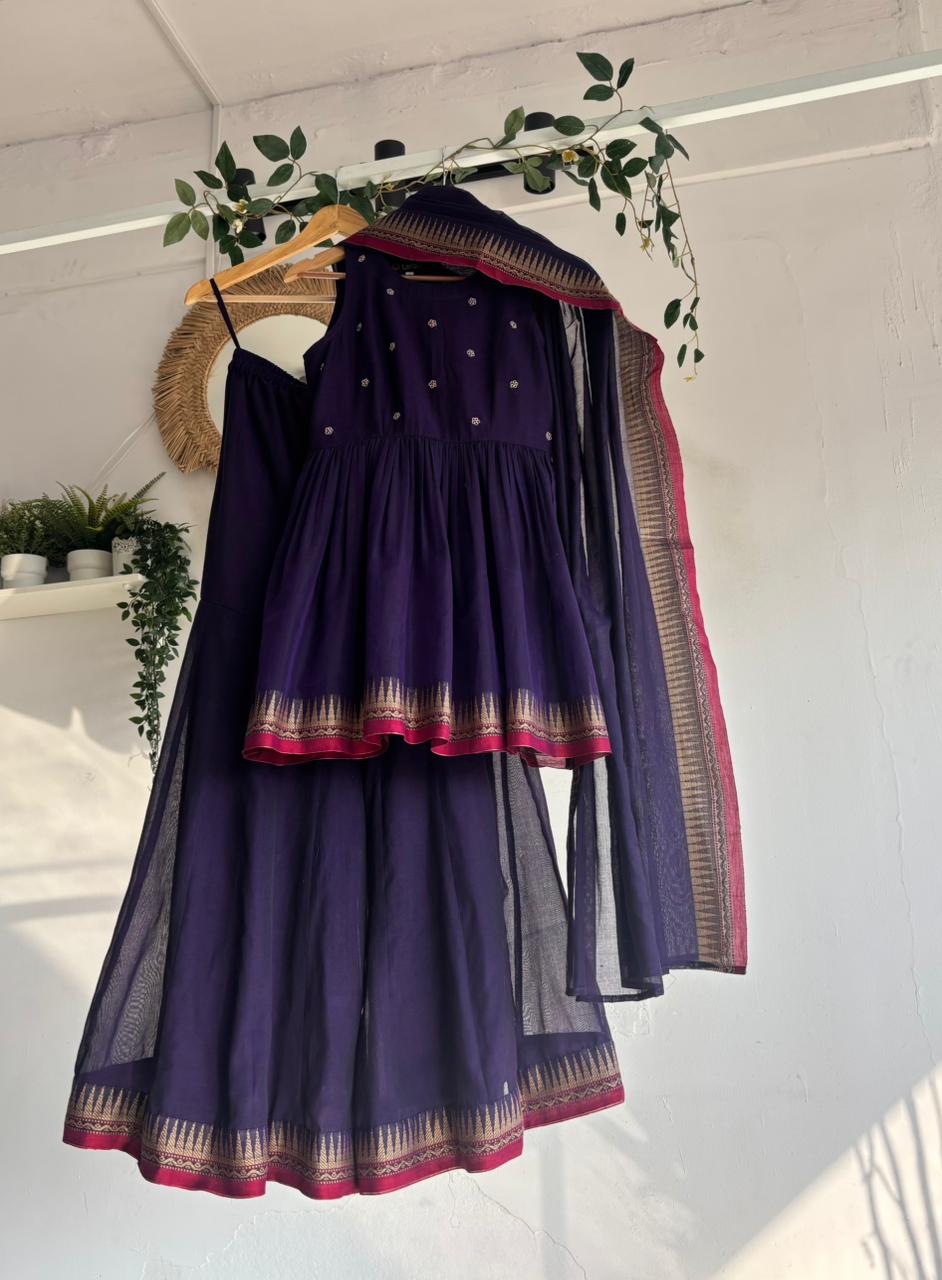Purple Narayanpet Sharara Set – handloom purple kurta with gold motifs, flared sharara, and matching dupatta with zari border displayed on hanger.