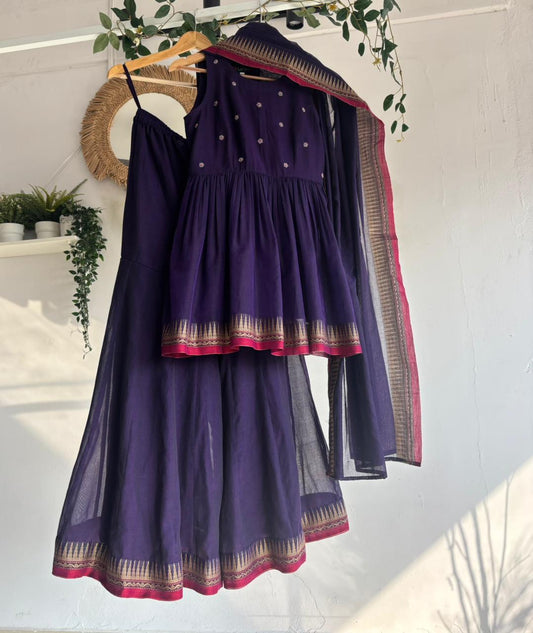 Purple Narayanpet Sharara Set – handloom purple kurta with gold motifs, flared sharara, and matching dupatta with zari border displayed on hanger.