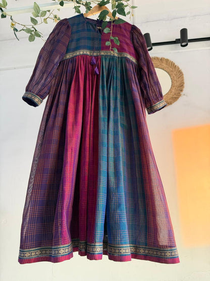 Queen’s Palette Narayanpet Dress – multi-hued handloom cotton dress in purple, magenta, and teal with zari borders, displayed on hanger.