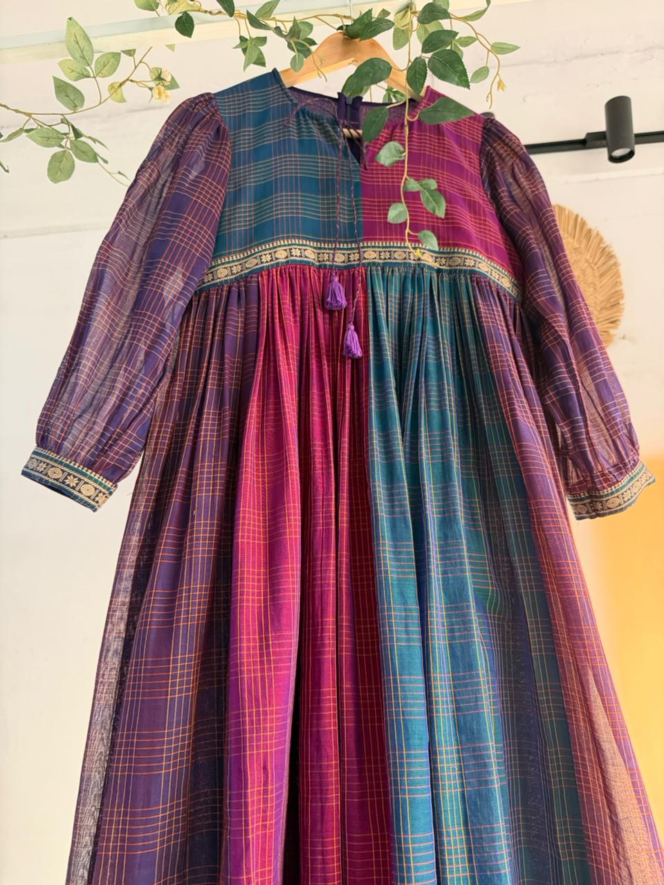 Queen’s Palette Narayanpet Dress – multi-hued handloom cotton dress in purple, magenta, and teal with zari borders, displayed on hanger.