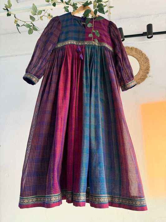 Queen’s Palette Narayanpet Dress – multi-hued handloom cotton dress in purple, magenta, and teal with zari borders, displayed on hanger.
